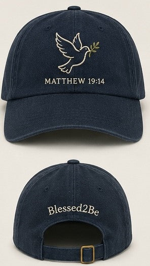 A navy blue baseball cap shown from the front and back. The front features an embroidered white dove holding an olive branch with the text 'MATTHEW 19:14' below it.
